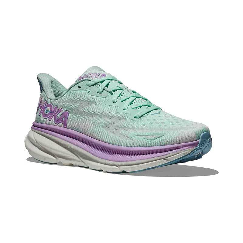 A Hoka Clifton 9 Sunlit Ocean/Lilac running shoe in pale green and purple, featuring a thick cushioned sole and breathable engineered mesh upper.