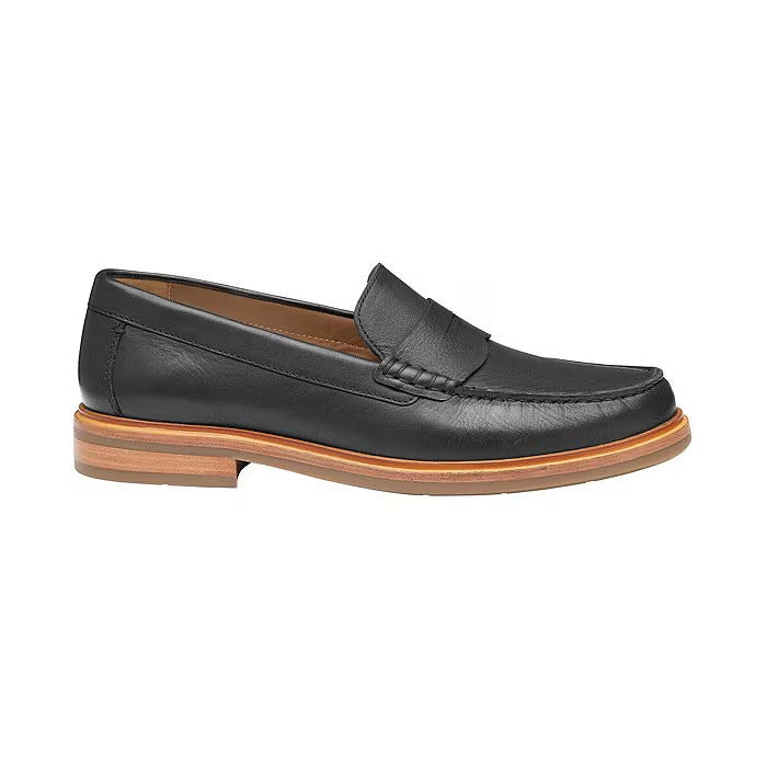 Johnston & Murphy Lyles Slip On Penny Black Full Grain with a TRUFOAM® footbed and a strap across the top, set against a white background.