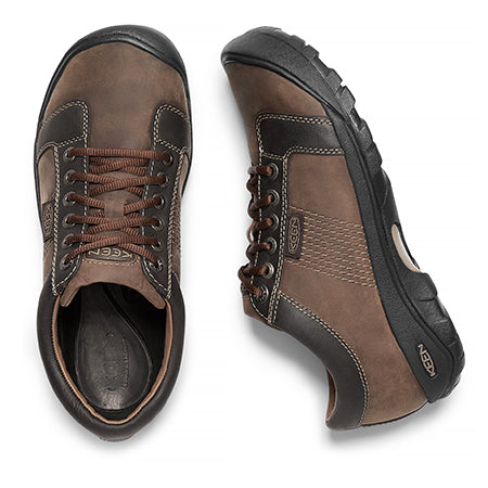 A pair of Keen Austin Chocolate Brown men&#39;s lace-up leather oxford shoes with rugged soles, viewed from above, isolated on a white background.