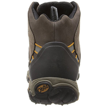 Rear view of a brown and black Oboz Bridger Mid Sudan Brown hiking boot with yellow accents, featuring a BDry waterproof membrane.