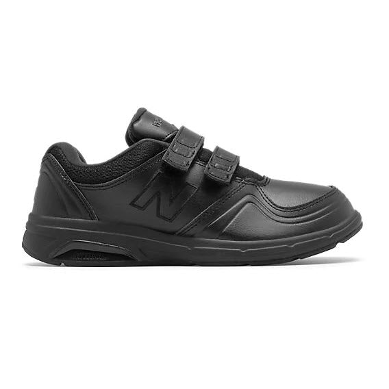 A black New Balance WW813HBK sneaker with double velcro straps and a thick sole for enhanced arch support, displayed against a white background.