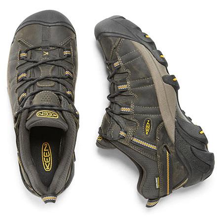 A pair of Keen Targhee II WP Ravin hiking shoes in dark gray with yellow accents, featuring an aggressive outsole, displayed from above, showcasing their tread and Keen branding.