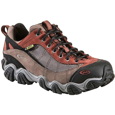A single Oboz Firebrand II WP Low Earth hiking shoe with brown and grey colors, featuring lace-up closure and a rugged, traction outsole.