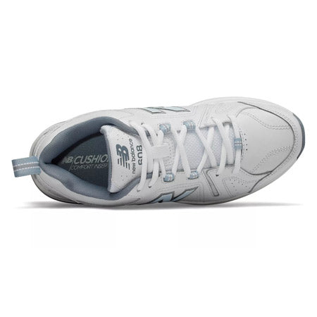 Top view of a New Balance 608V5 white/blue athletic shoe featuring blue accents and labeled cushioning, focused on the laces and insole design, including an ABZORB heel pad.