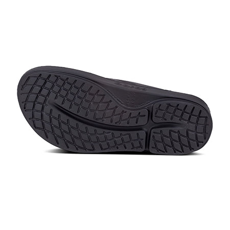 Black Oofos shoe sole with Patented footbed tread pattern on a white background.