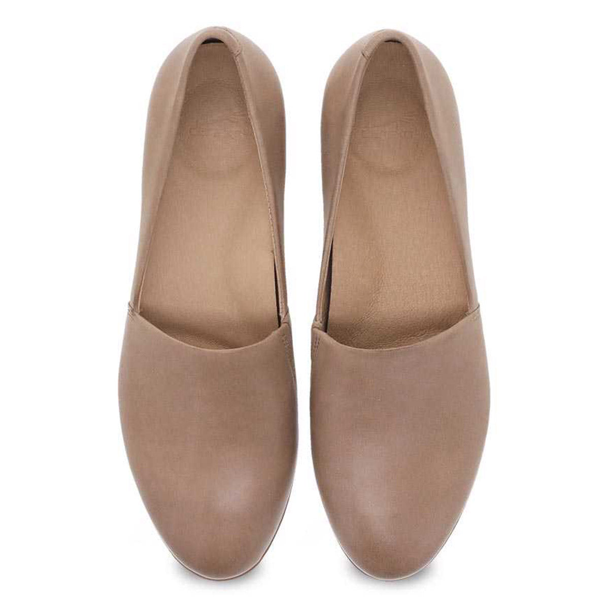 A pair of women&#39;s Dansko Larisa Tan flat shoes with arch support isolated on a white background.