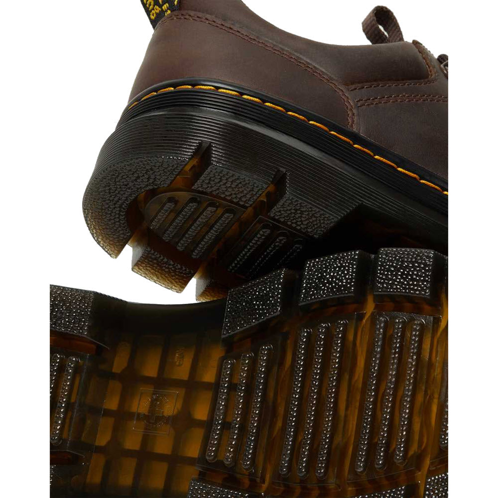 A close-up of a Keen Targhee II Cascade Brown/Golden Yellow - Mens leather boot with yellow stitching, eVENT waterproof technology, and an aggressive outsole with a translucent treaded design.