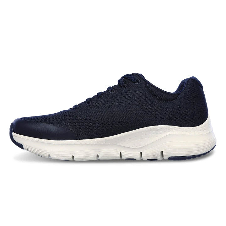 Side view of a single navy blue Skechers Arch Fit athletic walking shoe with white sole.