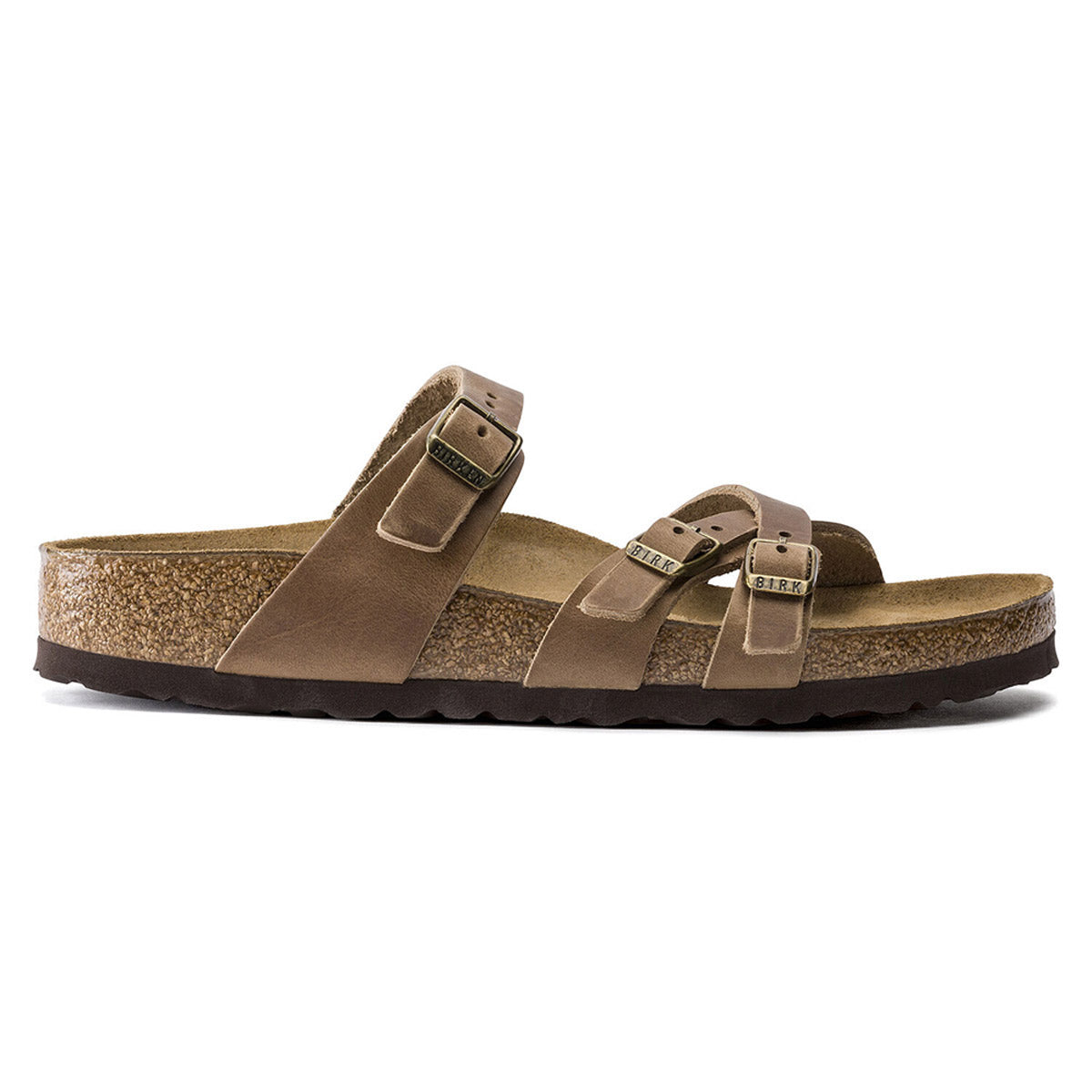 The Birkenstock Franca Tobacco for women features brown oiled leather, three adjustable buckled straps, a cork-latex footbed, and a dark textured sole—shown in side profile and crafted in Birkenstock’s signature style.
