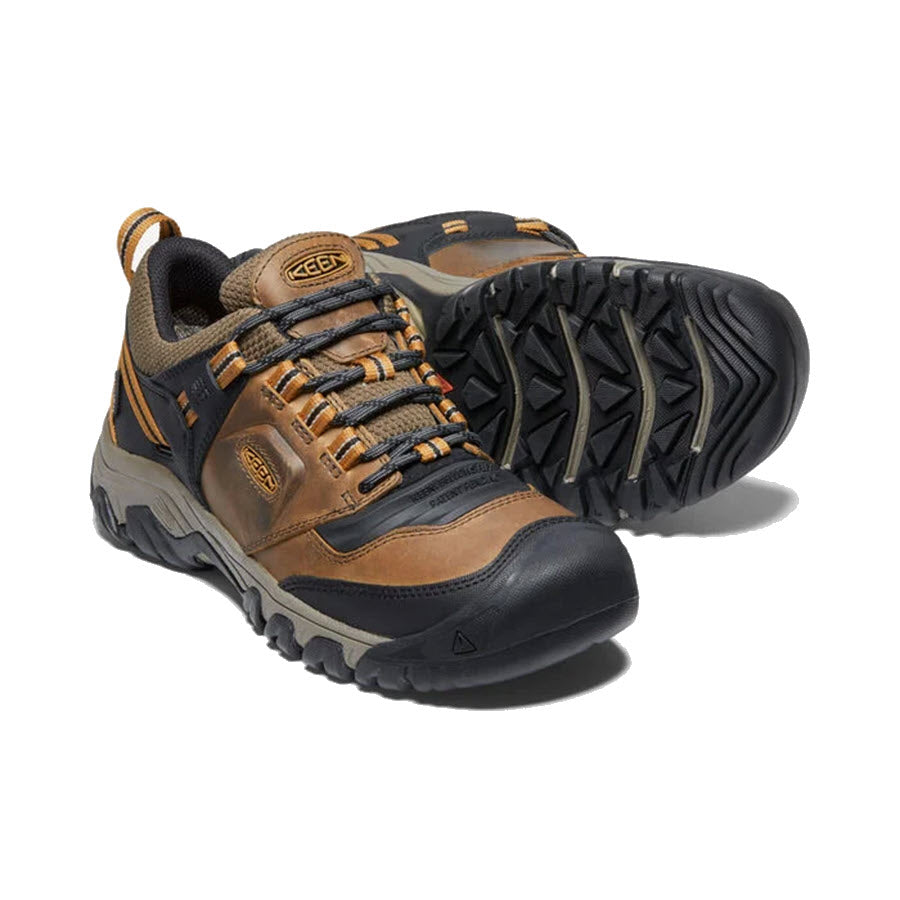 A pair of Keen Ridge Flex WP Bison hiking boots crafted from KEEN.DRY waterproof leather with a brown and gray color scheme, featuring robust laces and a sturdy sole.