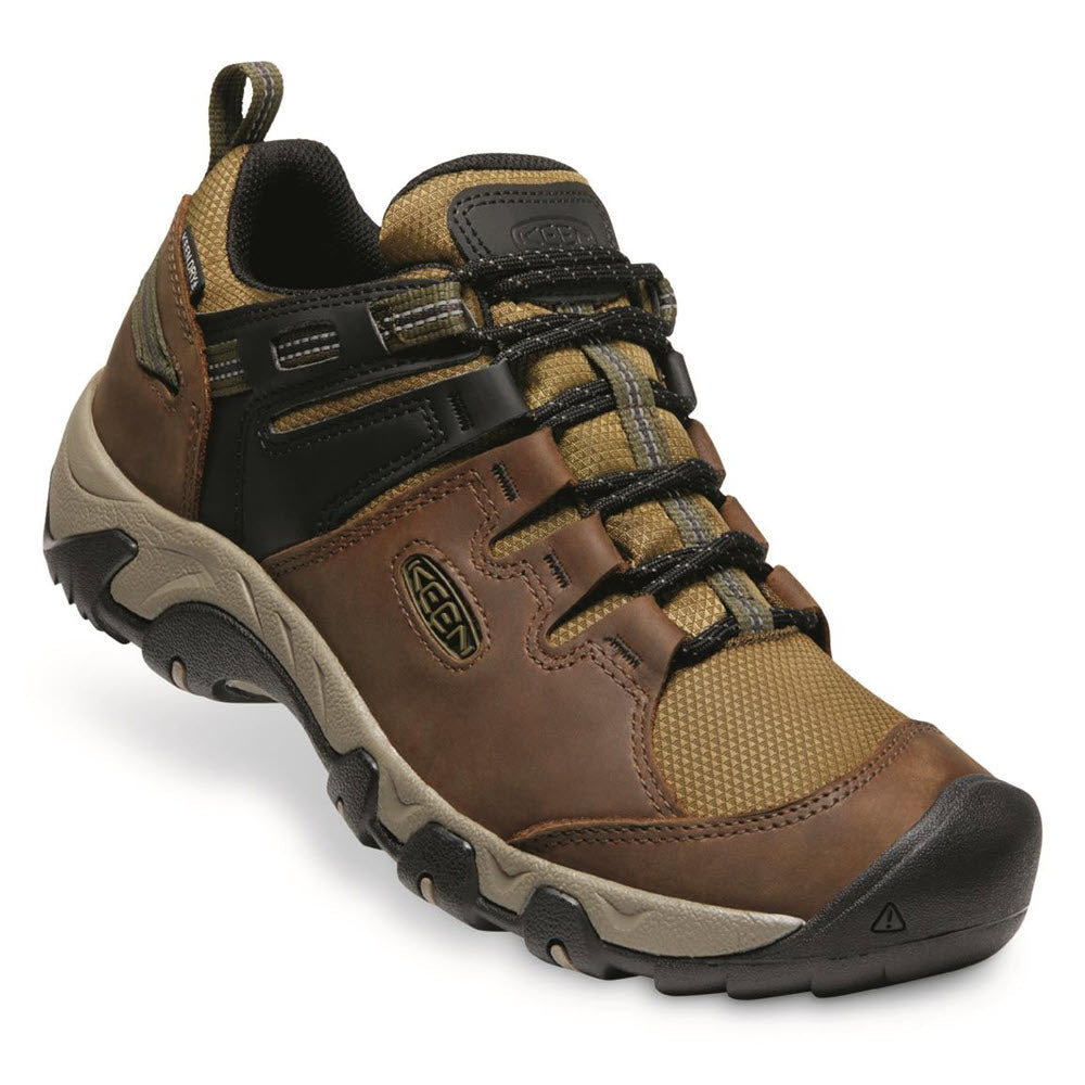 A Keen Steens Waterproof Brindle - Mens durable hiking shoe with a lace-up closure and a rubber toe guard, shown on a white background.