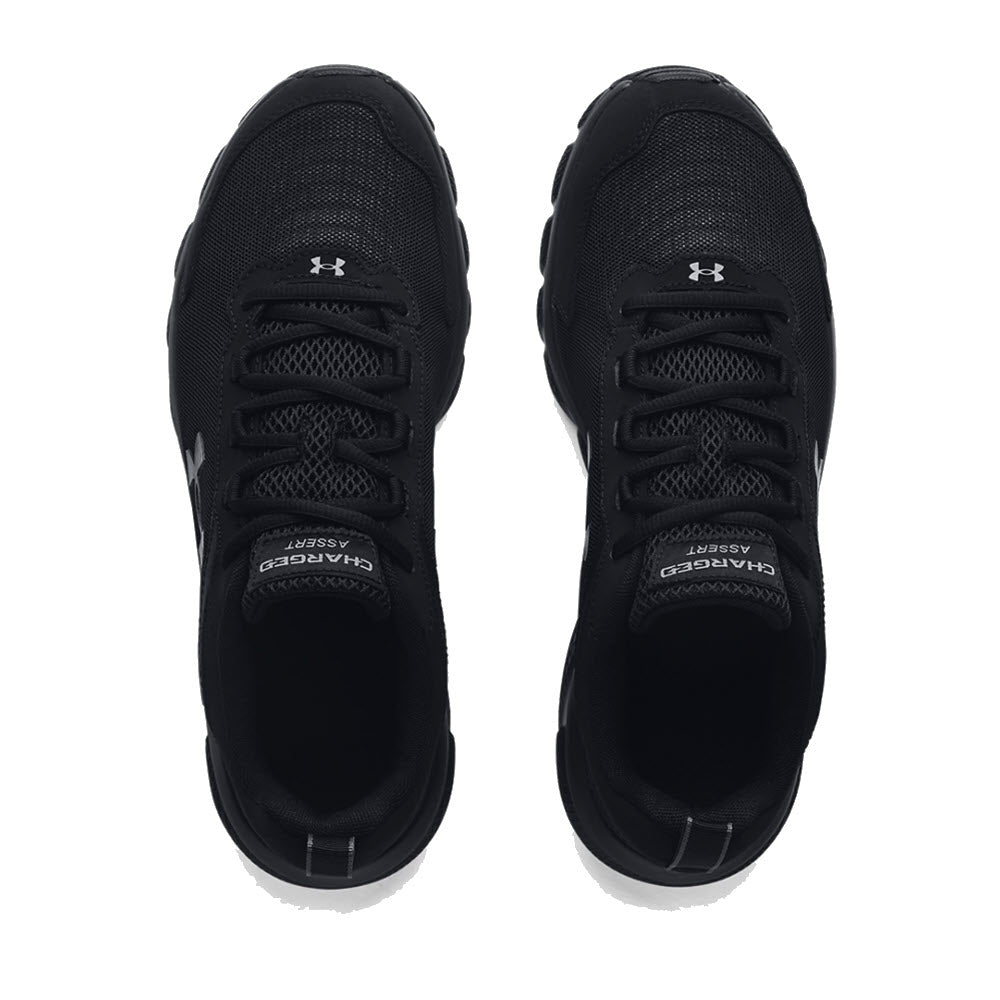 A pair of black Under Armour Charged Assert 9 men&#39;s athletic shoes, viewed from above, showcasing the brand logo on the sides and front.