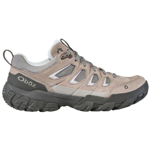 A single Oboz Sawtooth X Drizzle trail shoe, featuring a light gray and beige design with black accents, displayed on a white background.