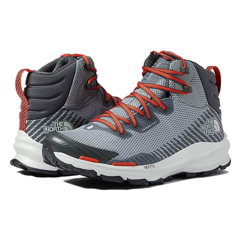 A pair of Men&#39;s North Face VECTIV Fastpack hiking boots with gray uppers and orange laces.