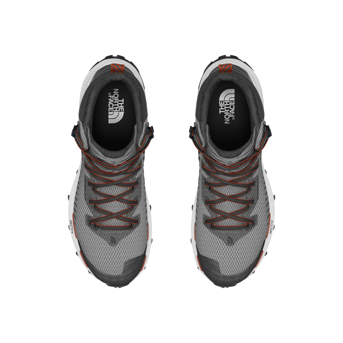 A pair of the North Face VECTIV Fastpack Mid Meld Grey hiking shoes viewed from above, featuring gray uppers with orange laces and black accents.