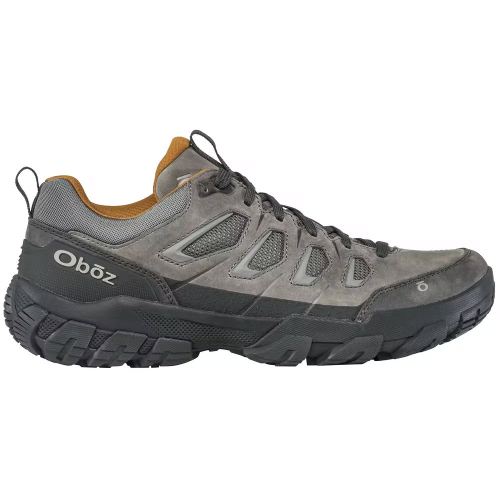 Side view of a gray Oboz Sawtooth X Low Hazy Gray hiking shoe with black and tan accents, featuring reliable traction.