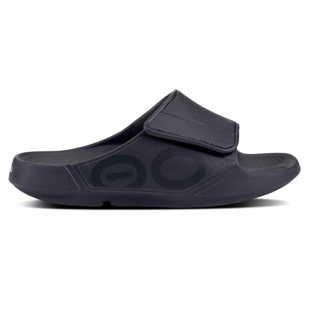 A single navy blue Oofos Sport Flex slide sandal with a wide strap and a large circular logo on the side, displayed against a white background.