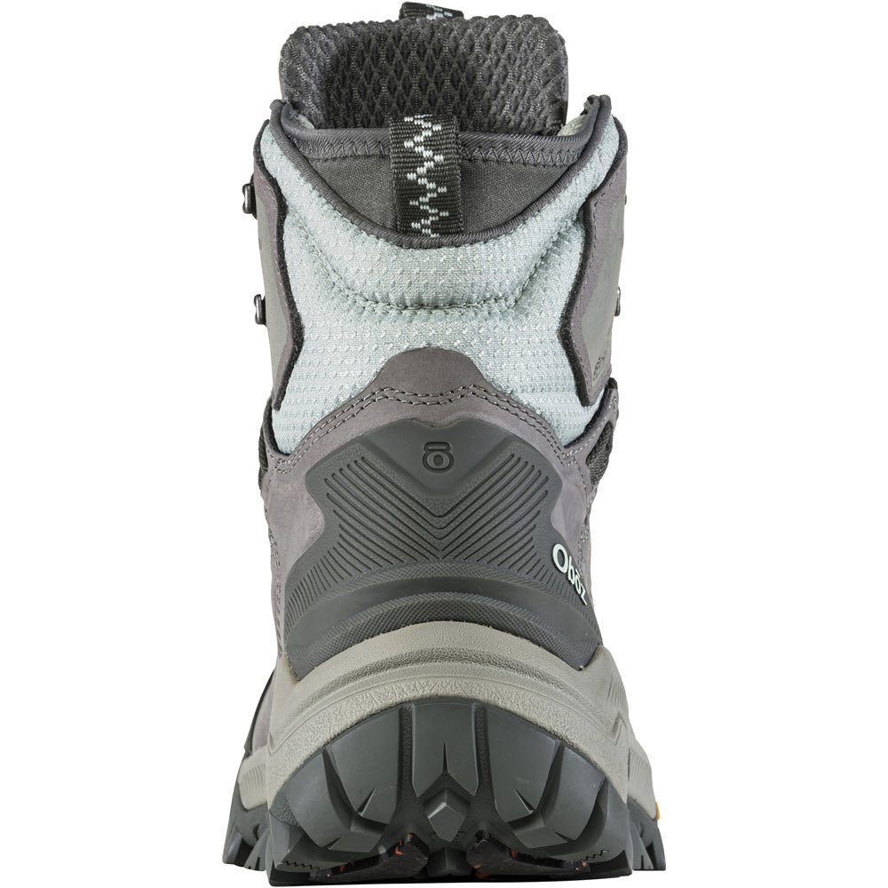 Rear view of a Oboz Bangtail Mid Insulated Bdry Winter Quartz - Women&#39;s hiking boot showing tread detail, cushioned ankle support, and branding on the heel.