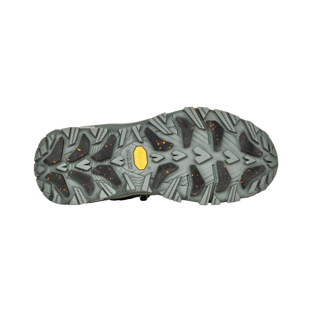 Sole of the OBOZ BANGTAIL MID INSULATED BDRY WINTER QUARTZ - WOMENS hiking boot displaying a multi-directional tread pattern with a central yellow logo.