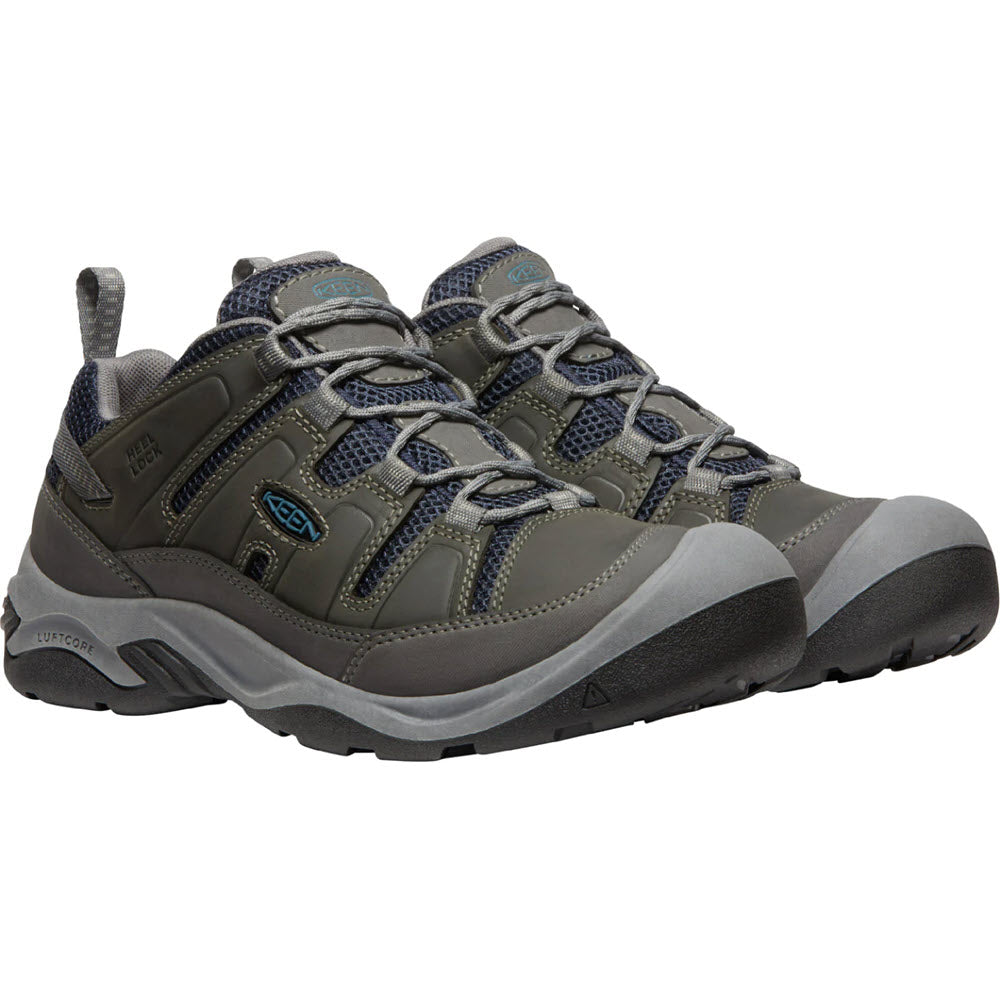 A pair of grey and blue Keen® Circadia Vent hiking shoes with sturdy soles and webbing eyelets system.