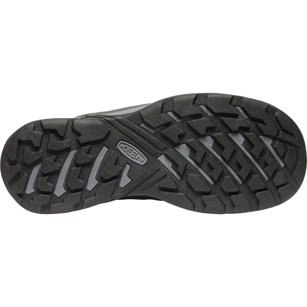 Black rubber sole of a shoe with a rugged tread pattern designed for tough terrains and a visible Keen logo.