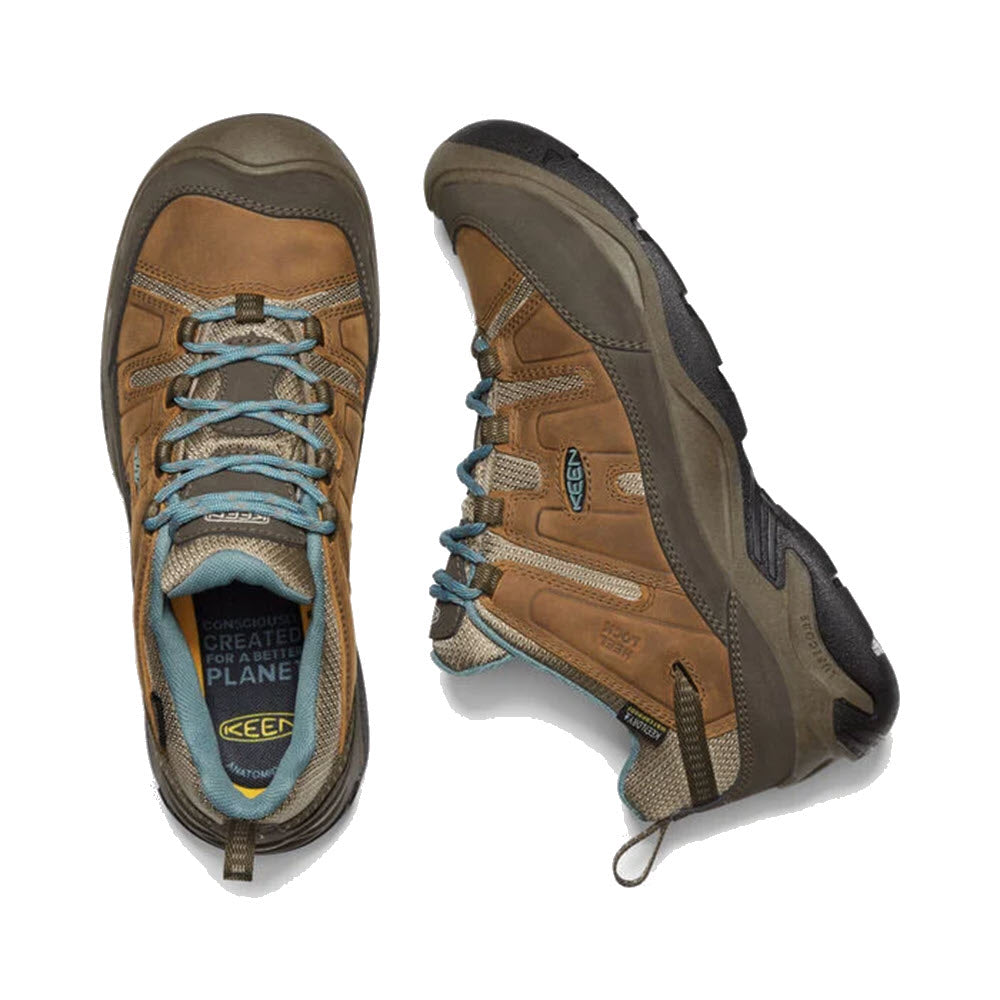 A pair of Keen KEENDRY waterproof hiking boots with brown leather and blue laces, viewed from above on a white background.
