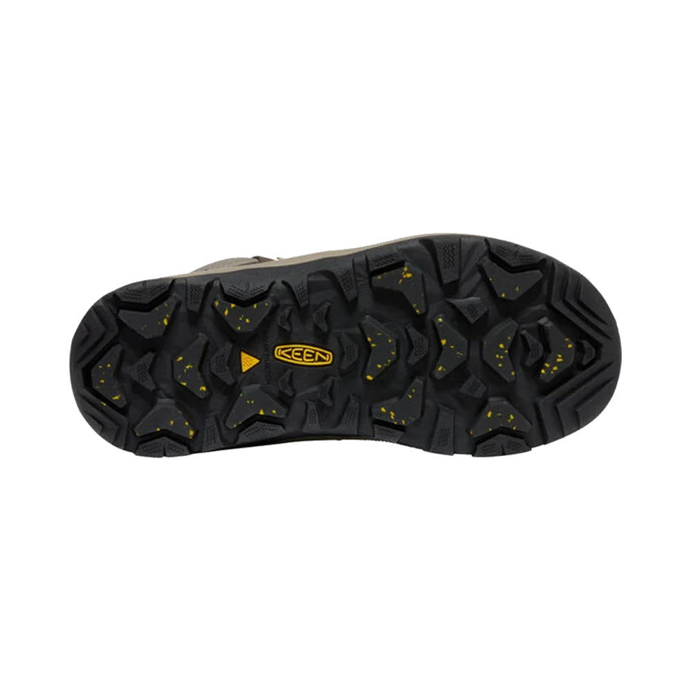 Sole of a Keen REVEL IV MID POLAR COFFEE BEAN boot for women featuring a black tread pattern with yellow accents and the Keen logo in the center, designed for exceptional grip.