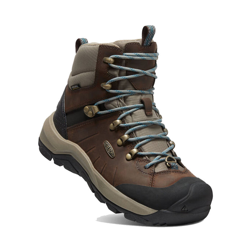 Brown and gray Keen winter boots for women with blue laces on a white background.