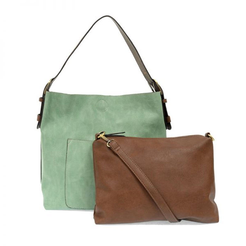Two JOY SUSAN HOBO BAG BERMUDA GREEN shoulder bags, one with an exterior pocket and one brown with a zipper, against a white background.