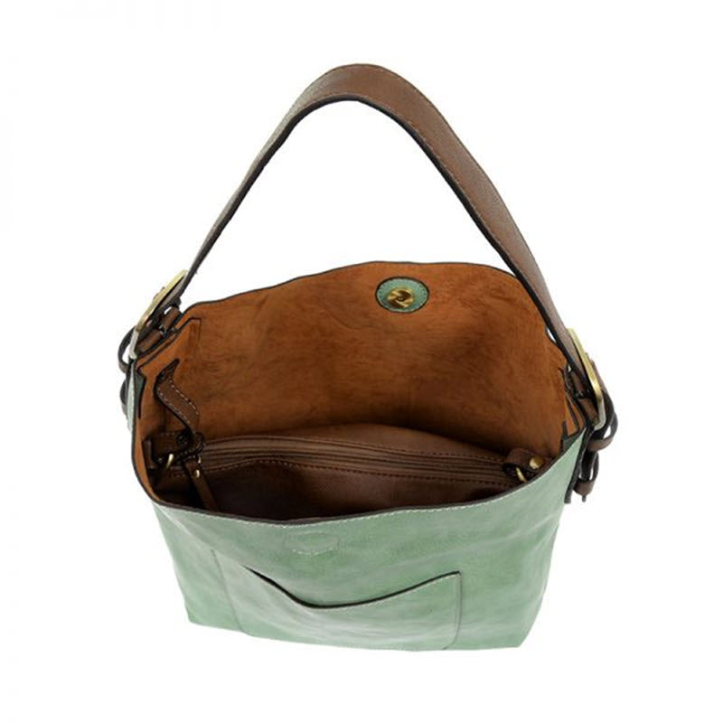 An open vegan leather Joy Susan classic hobo bag Bermuda Green with a brown interior, viewed from above.