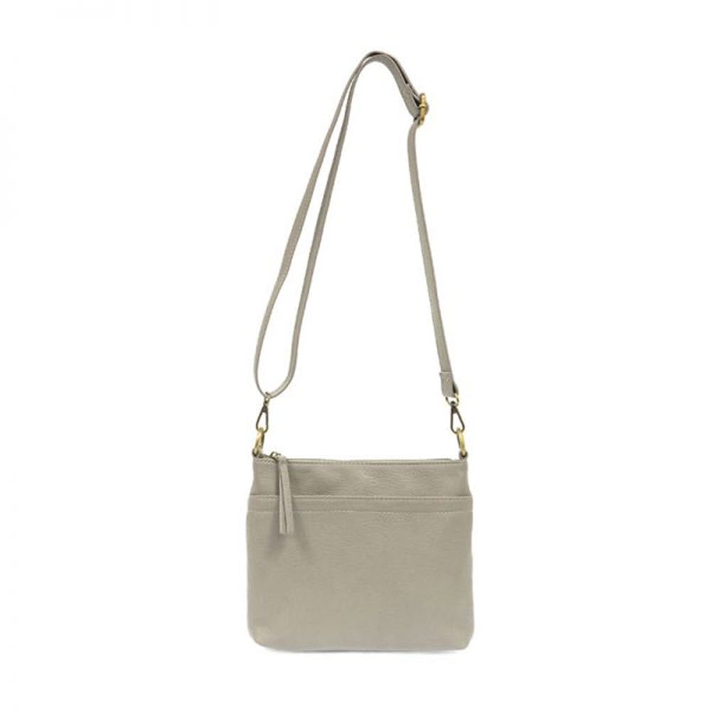 Joy Susan Layla grey double-zipper crossbody bag with adjustable strap, exterior pockets, and zipper closure.