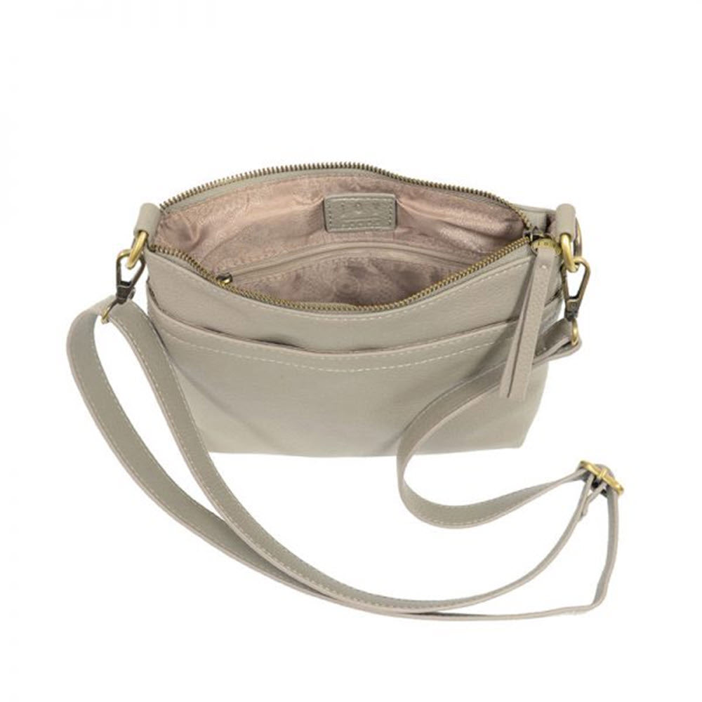 Grey vegan leather Joy Susan Layla top zip bag with gold-tone hardware, exterior pockets, and a zipper closure.