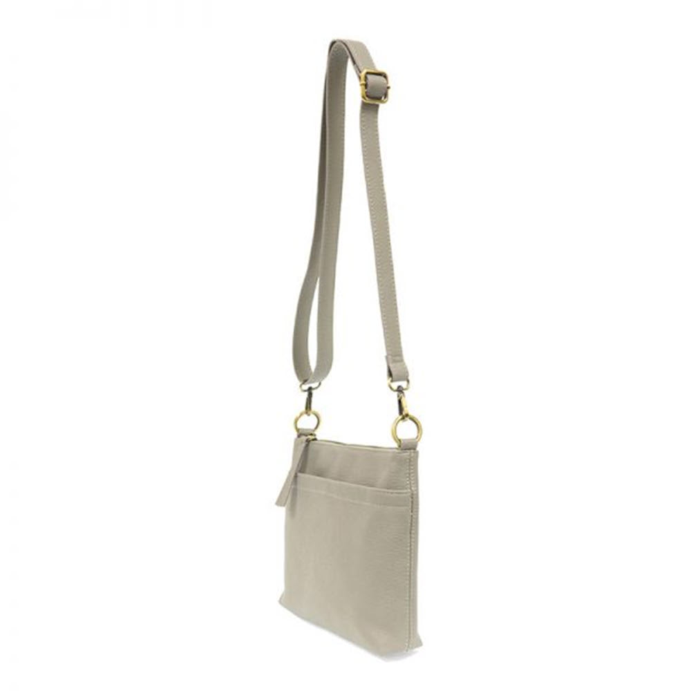 Joy Susan Layla double-zipper crossbody bag in beige with adjustable strap, gold-tone hardware, and exterior pockets.