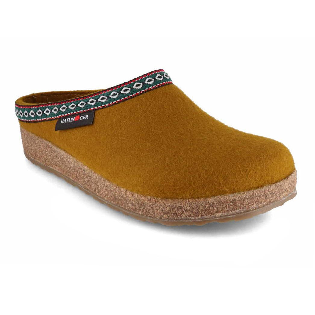 A Haflingers brown clog with a decorative multicolored band around the rim and a cork footbed, set against a white background.