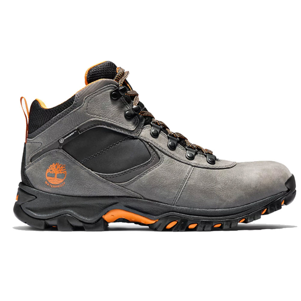 A gray Timberland MT. Maddsen Mid Waterproof Dark Grey hiking boot with orange accents on the sole, a compression-molded EVA midsole, and a logo on the side.