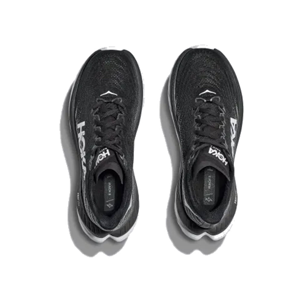 A pair of black HOKA MACH 5 running shoes placed side by side on a white background, viewed from above.