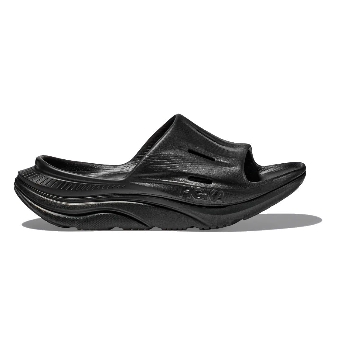 Black HOKA ORA Slide 3 slip-on recovery sandal with a sugarcane footbed against a white background.