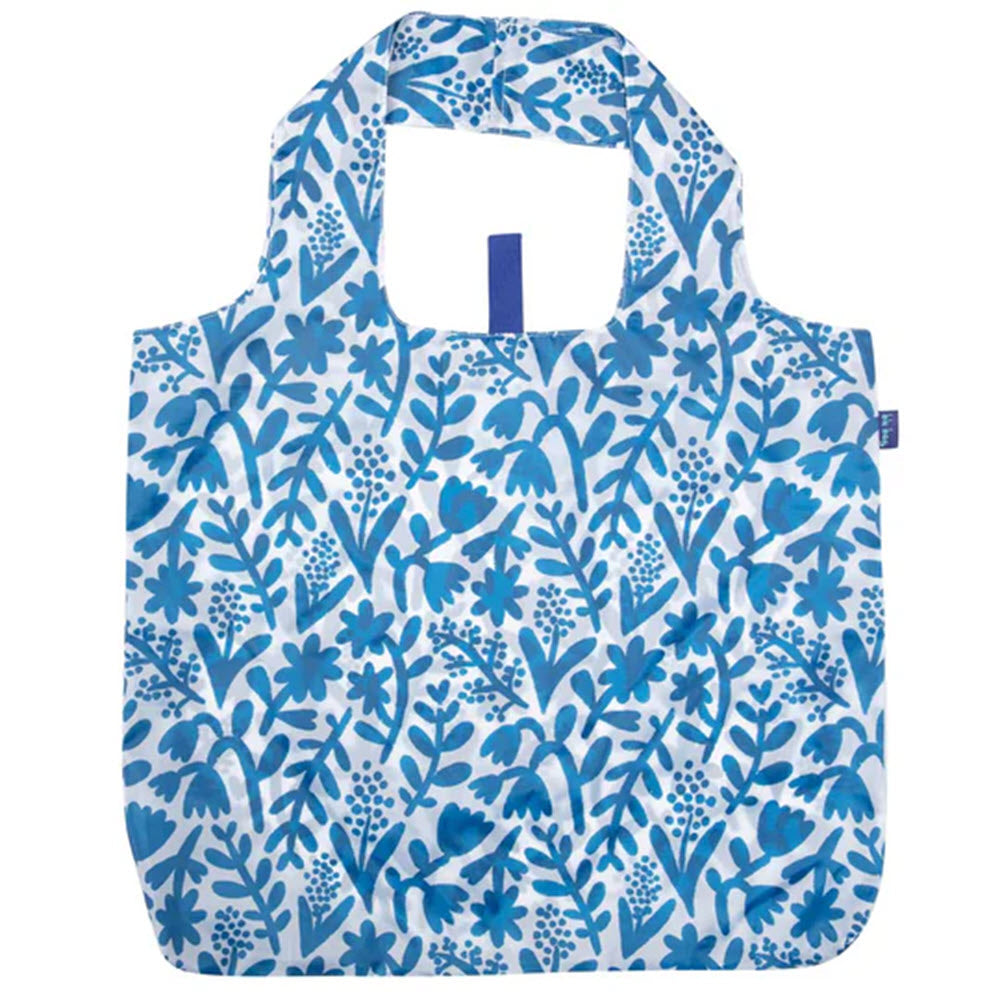 A reusable shopping bag with a blue floral print on a white background, featuring built-in handles - the Rockflowerpaper BLU BAG BOTANICAL.