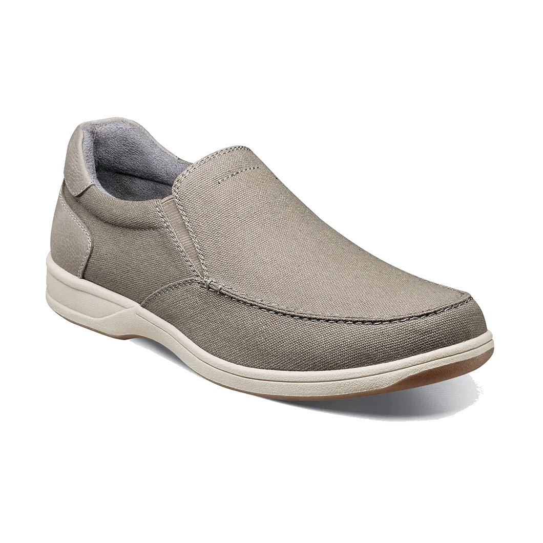 Single beige Florsheim Lakeside Slip On Canvas Stone shoe with a canvas upper and rubber sole, displayed on a white background.