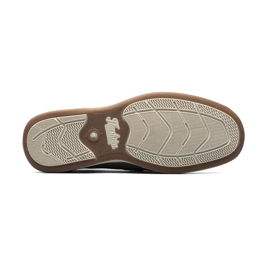 The sole of a Florsheim Lakeside Slip On Canvas Stone shoe with a herringbone pattern and a logo visible.