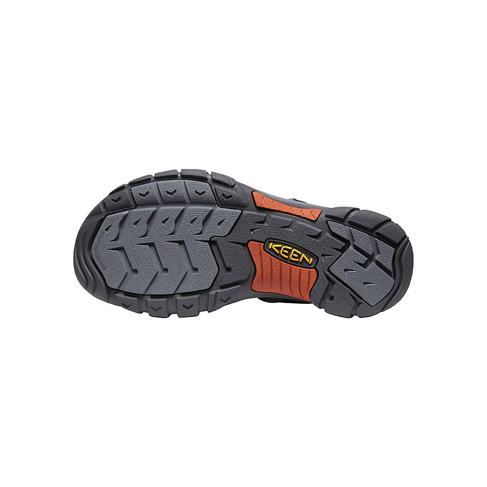Bottom view of a Keen Newport Slide Sandal Sky Captain Bombay Brown - Mens showing a black and gray tread pattern with an orange Keen logo.