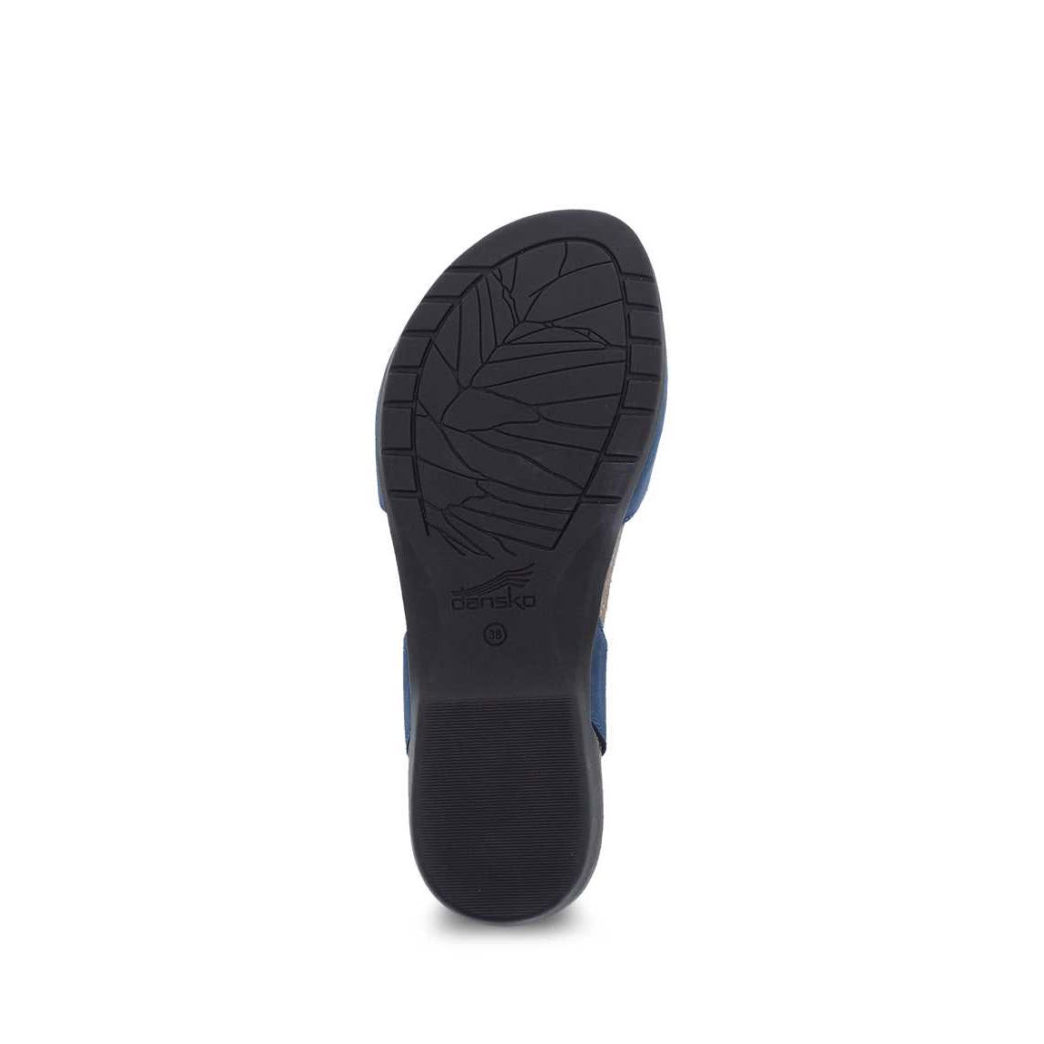 Bottom view of a Dansko Rowan Navy - Womens shoe sole featuring a textured rubber outsole and a blue accent, isolated on a white background.