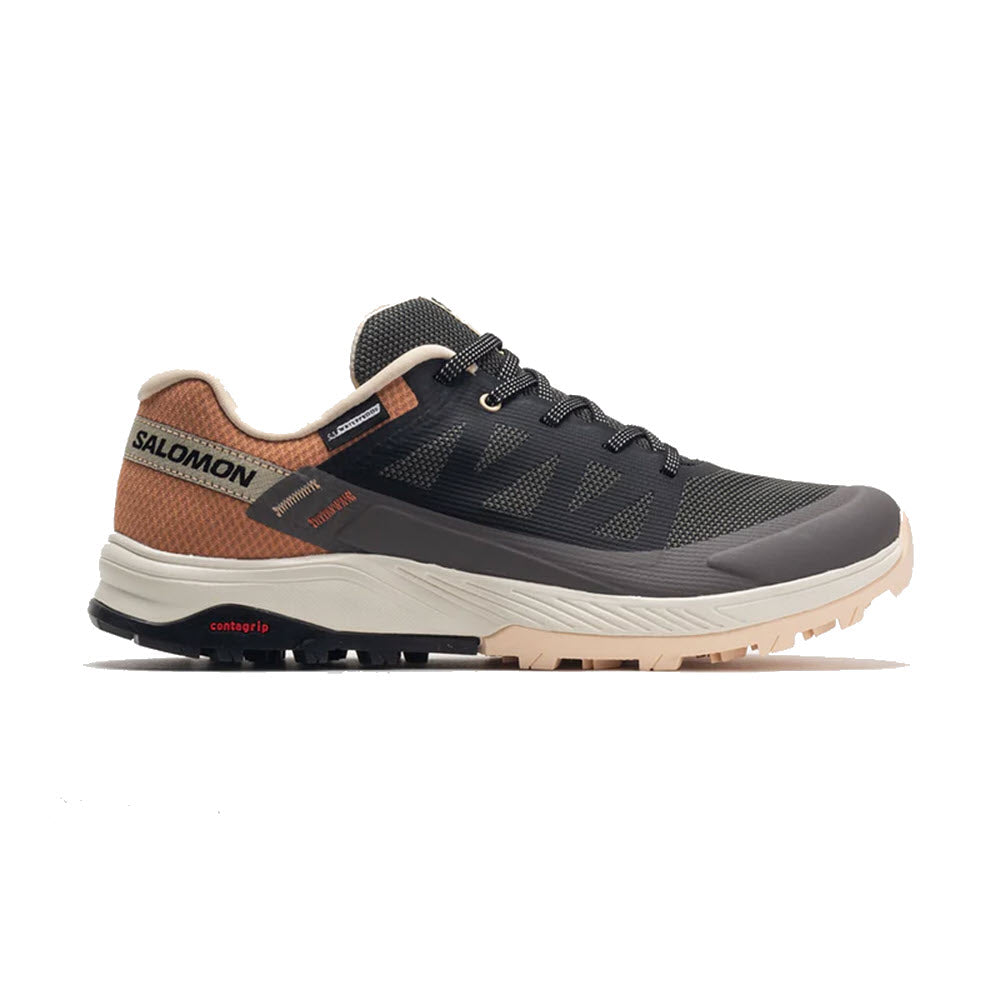 A Salomon Outrise CSWP Magnet hiking shoe featuring a dark gray upper with light brown accents, black laces, and a robust beige sole.
