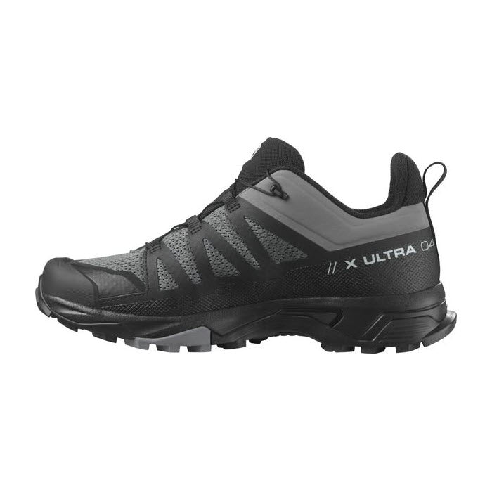 Side view of a black hiking shoe with prominent Contagrip® sole system, labeled &quot;SALOMON X ULTRA 4&quot; on the side, featuring gray accents and breathable mesh panels.