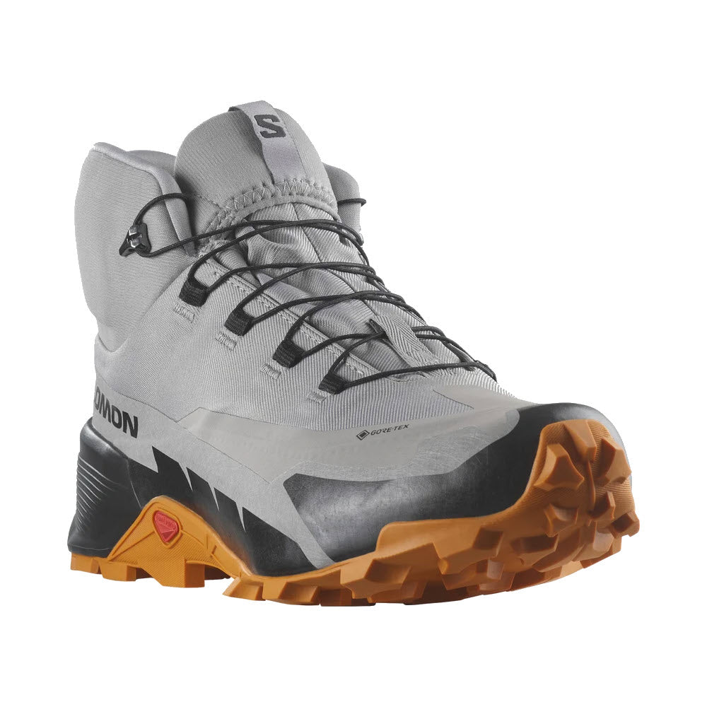 A side view of a Salomon Cross Hike 2 Mid GTX hiking boot with grey upper, black detailing, and a chunky orange sole.
