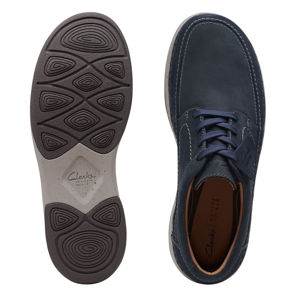 A top view of a Clarks Nature 5 Lo Oxford Navy Combi - Mens shoe alongside its patterned sole, displayed against a white background.