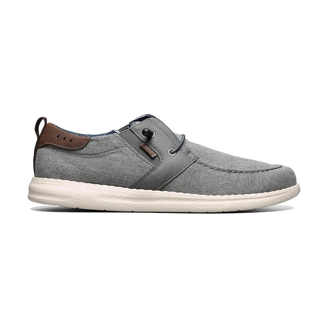 Gray Nunn Bush Brewski Moc Toe slip-on shoe with white sole and brown leather accent on the heel, isolated on a white background.