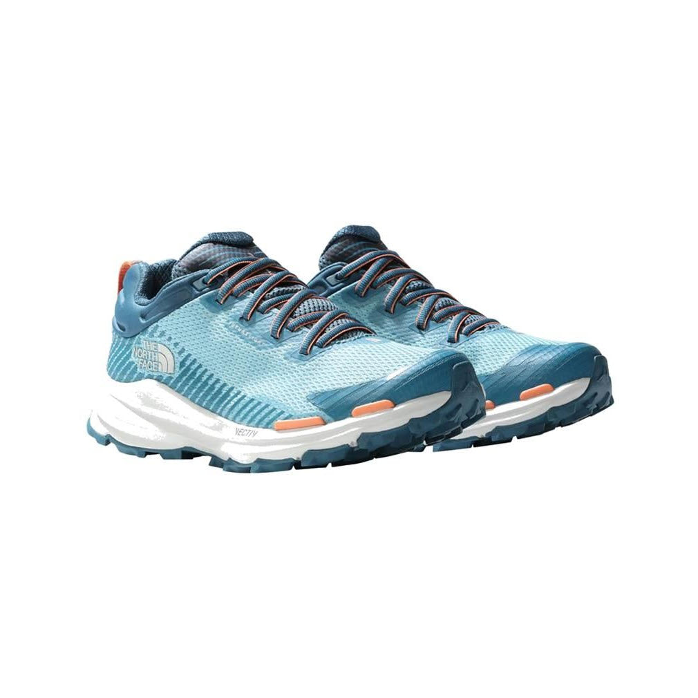A pair of light blue North Face VECTIV FASTPACK Futurelight Reef Waters/Blue Coral running shoes with orange and black accents, featuring an OrthoLite insole, displayed on a white background.