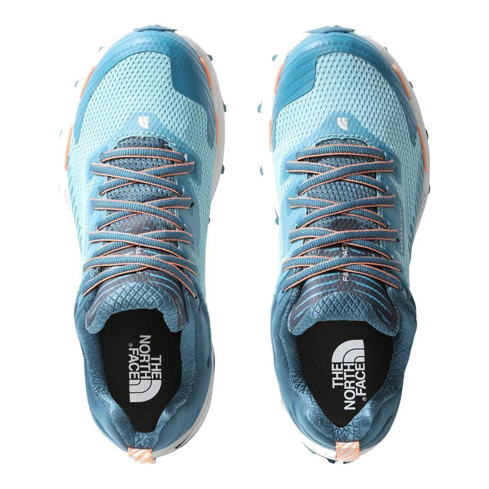 Top view of a pair of light blue and orange North Face VECTIV FASTPACK FUTURELIGHT REEF WATERS/BLUE CORAL trail running shoes featuring a Surface Control rubber sole.