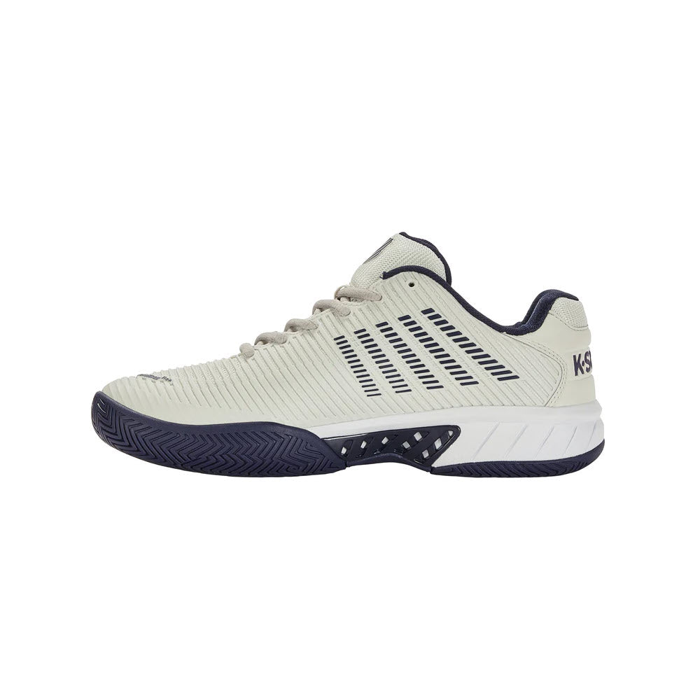 Side view of a light grey and navy blue K-Swiss Hypercourt Express 2 Vaporous Gray/Peacoat tennis shoe with a patterned sole and ventilated side panels.